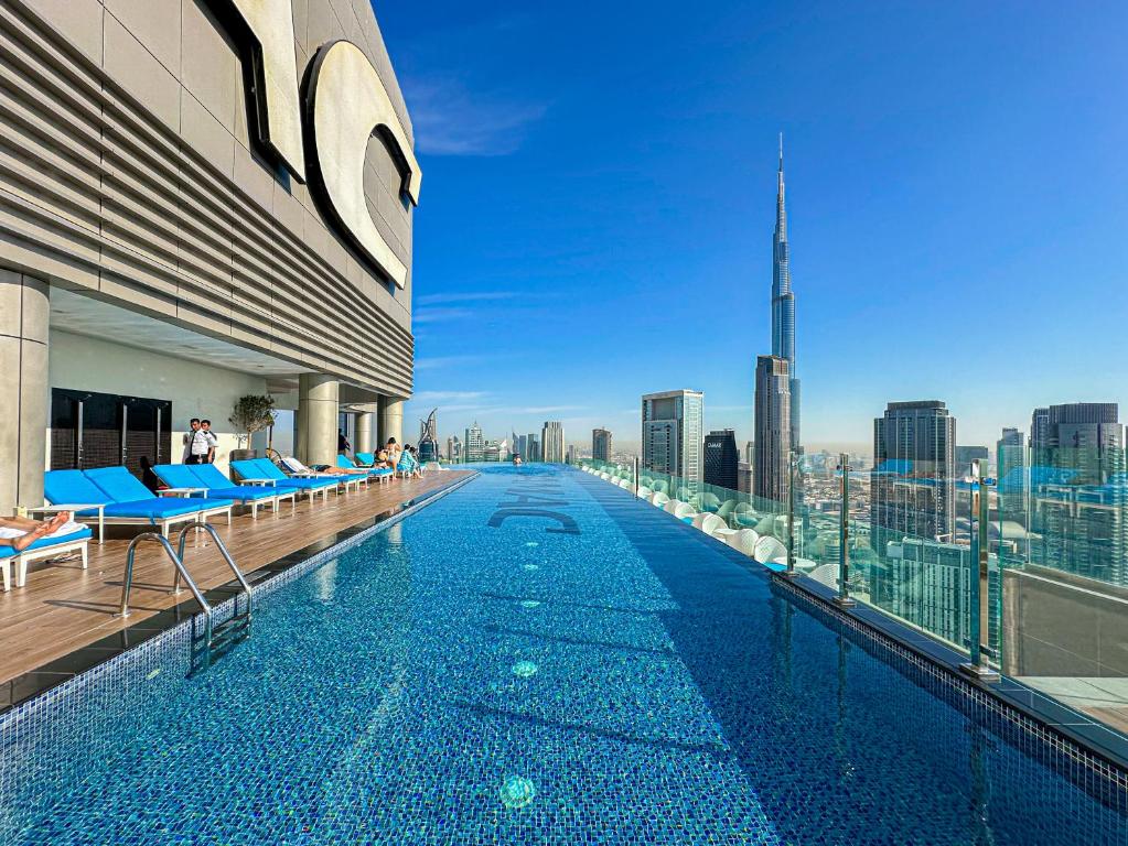 64th floor rooftop pool offering amazing Burj Khalifa views, 2BR apartment in Paramount Hotel Midtown